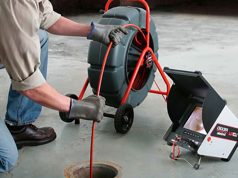 A man inspecting sewer line with camera in New York & New Jersey.